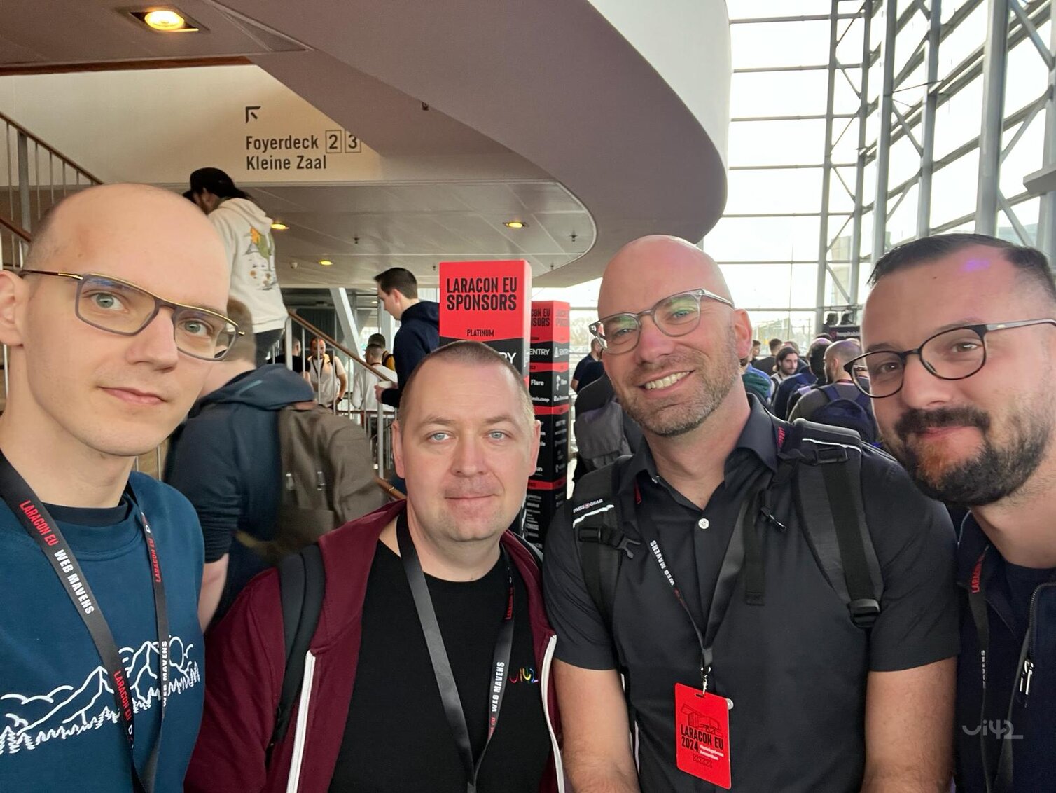 A group of men at the Laracon EU conference with the sign Laracon EU Sponsors in the background