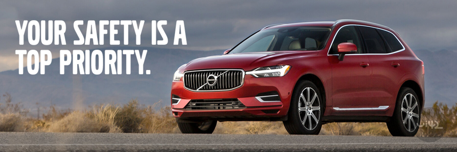 Red SUV on the road with the text 'YOUR SAFETY IS A TOP PRIORITY'